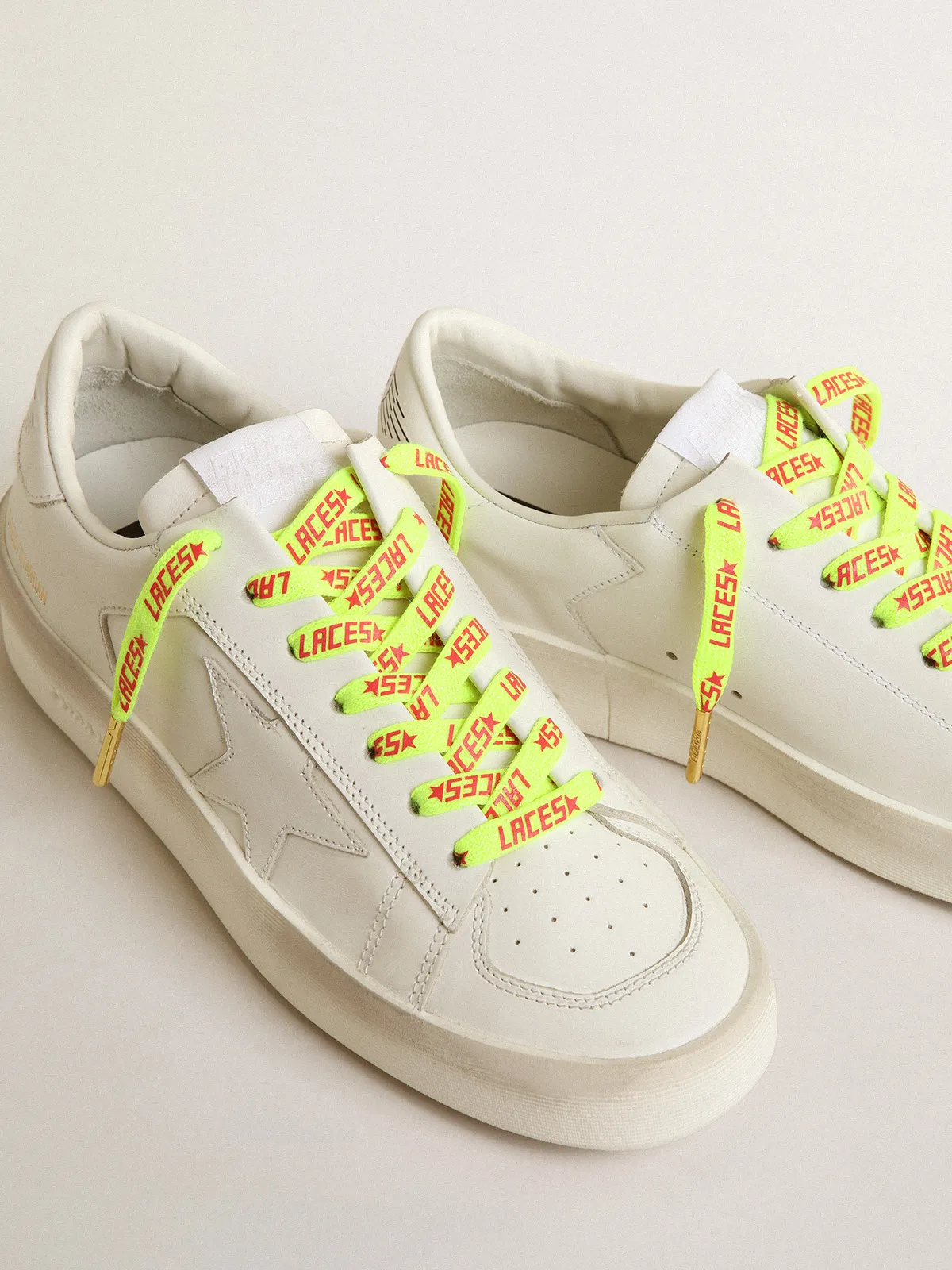 Fluorescent yellow laces with contrasting orange ‘Laces’ lettering